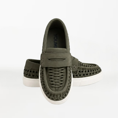 A pair of olive green woven slip-on loafers with white soles, displayed against a clean white background.