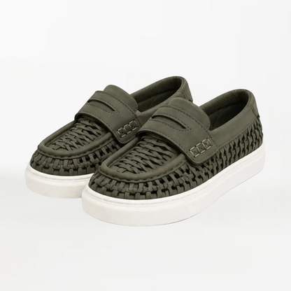 A pair of olive green woven slip-on shoes with white soles, displayed on a clean white background.