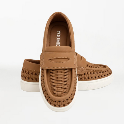 A pair of tan woven slip-on shoes with white soles, shown from the front and side against a plain white background.