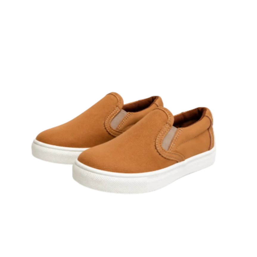 A pair of toddler slip-on sneakers in a warm camel brown color with white rubber soles, displayed on a clean white background.