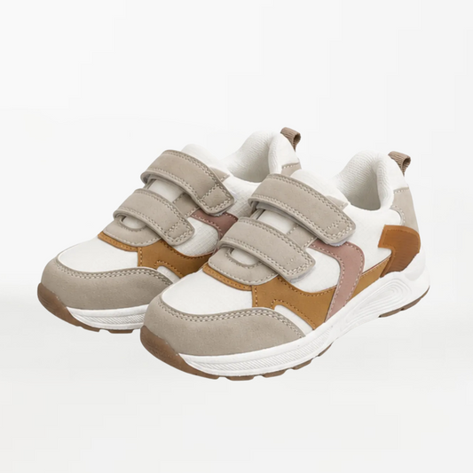 A pair of children's low-top sneakers in beige, white, and brown, featuring double hook-and-loop strap closures and a chunky sole, shown on a plain white background.
