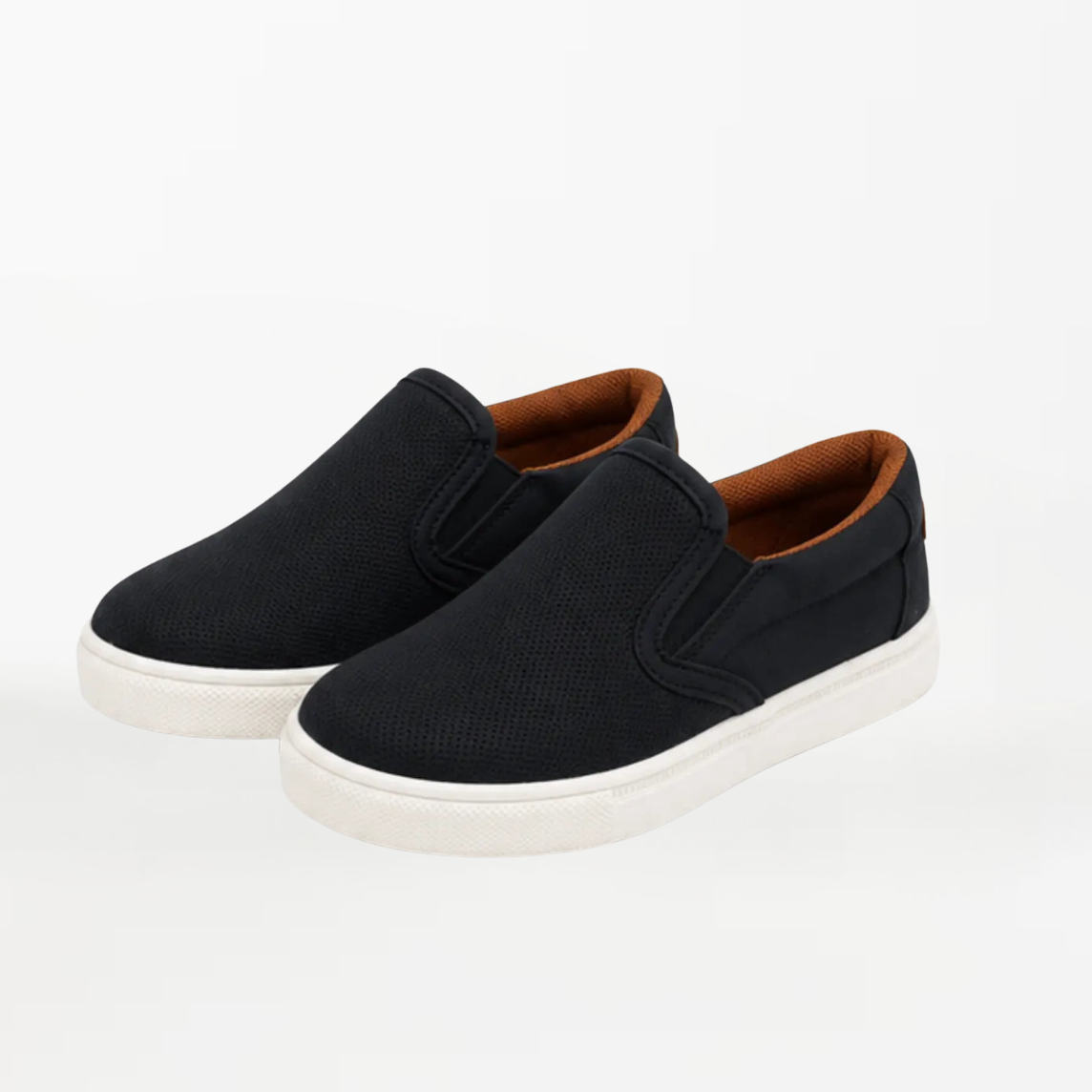 A pair of black slip-on canvas sneakers with brown lining and white soles, photographed on a clean white background.