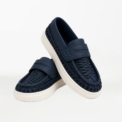 A pair of navy blue slip-on loafers with woven textured uppers and white soles, displayed on a clean white background.